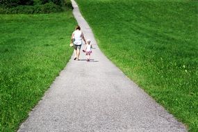 mom with a baby on a walk on a sunny day