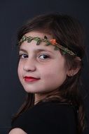 portrait of a happy little girl on a dark background