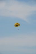 Yellow parachute in a sky