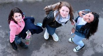 three schoolgirls look up