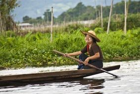 a peasant woman is sailing in Inle Lake, Asia