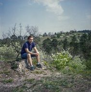 young guy is resting in a hike