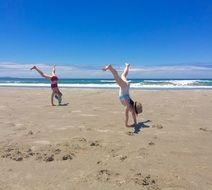 walking hands on the beach in new zealand