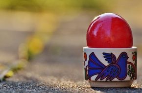 bright red easter egg in stand