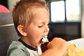 Boy is eating a Birtday cake