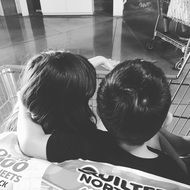 brother and sister are sitting on the couch