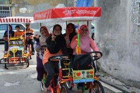 muslim women are sitting in a car