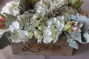 bunch of flowers in vintage box with writing love