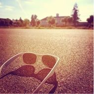white sunglasses on asphalt