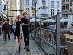 Happy couple in Love walking by pavement in old city