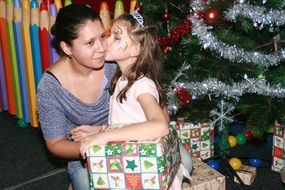 mother and daughter near the Christmas tree