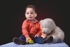 child with a soft toy at a photo shoot