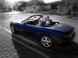 happy young couple in Blue Sports Car