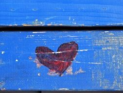 red heart on a blue wooden surface