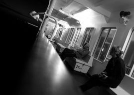 black and white photo of the interior of a commuter train