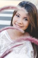 portrait of a teenage girl with long hair and in a white blouse