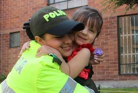 police girl hugs a colombian little girl