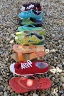 multi-colored pebble shoes on the beach