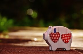 pink ceramic piggy bank with red hearts