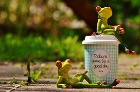 frogs near coffee as a positive day symbol