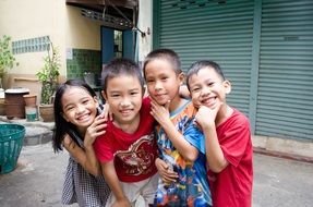 four happy asian kids posing together