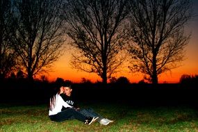 romantic couple on a background of bright orange sunset