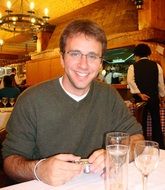 handsome young man at a table in a restaurant