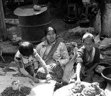 family sells on market black and white photo, burma