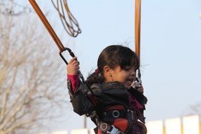 happy little girl on bungee