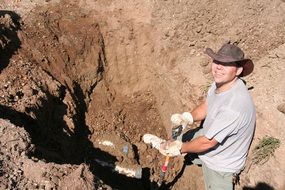 Smiling asian man Digging ground