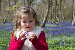 child among the colorful blooming spring forest