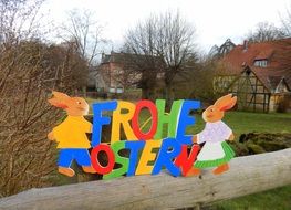 painted Easter bunnies on the background of houses