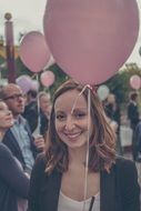 people with pink balloons close up