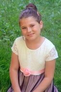 Smiling child Girl sitting on Grass, Portrait