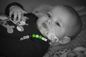sweet baby with baby's dummy