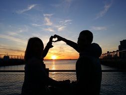 the couple folded their hands in the shape of a heart