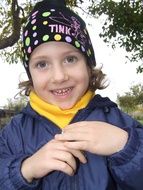 girl in a hat with inscriptions on the background of nature