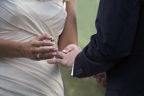 Wedding, Bride holds Ring at Groomâs hand