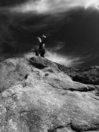 boy on a rock black and white photo