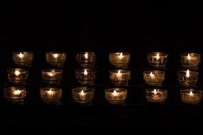 lighting of tea candles in a church