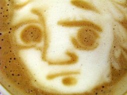 image of a sad face on coffee foam