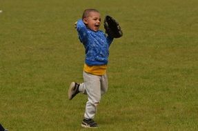 baseball boy running on green field