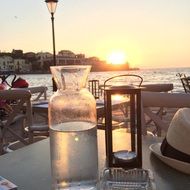 restaurant on the promenade in crete at sunset