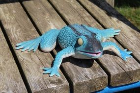 blue toy Frog on Bench