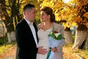 Couple in Love, happy man and Pregnant woman in autumn park