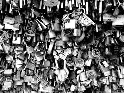 black and white photo of padlocks on the bridge