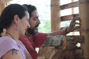 happy woman with drill and man at Construction work, Couple in Love