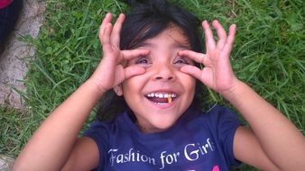 Portrait of happy child on green grass