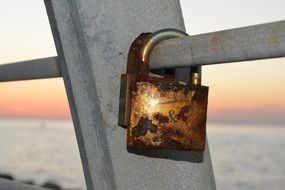 rusty love lock on railing close up