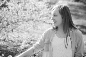 Black and white outdoor portrait of the nice smiling girl